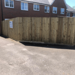 Feather edge fencing with DeckRight sign on