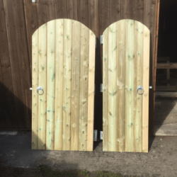 Single tongue and groove gates leaning against shed