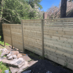 Solid fencing with gapped strips at the top in a back garden