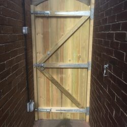 Tall single tongue and groove gate from back
