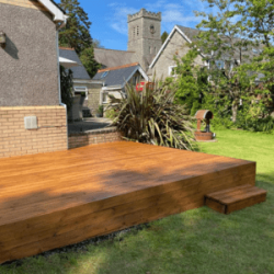 Timber decking area in Bridgend leading to grass