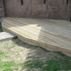 Timber decking in corner of garden