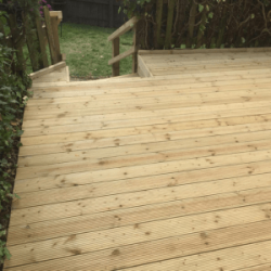 Timber decking steps going down into garden
