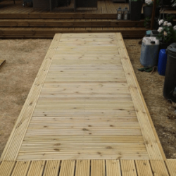 Timber decking walkway leading to timber decking area